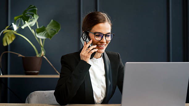 istock Stylish young woman working on a laptop in a modern office. 2224791895