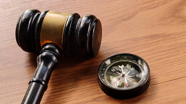 istock Gavel and Compass on Wooden Table 2224792844