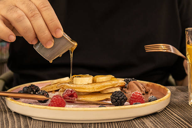 istock Maple Syrup Poured over Berry-topped Pancakes 2224795745