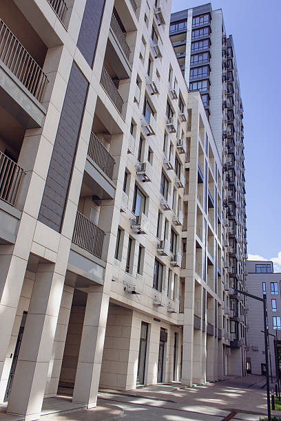 istock Downtown district with trees and lawn. High rise building on sunny day. Modern architecture. Business office building. Geometric lines in architecture. Modern building exterior. 2224796881