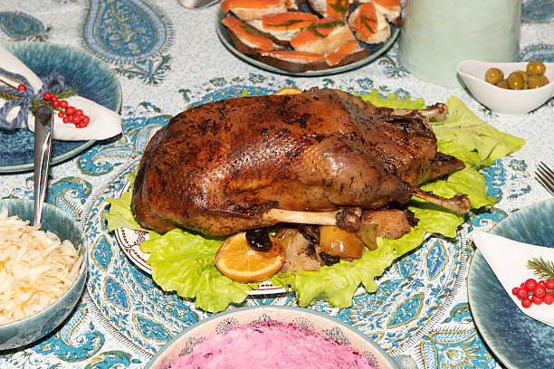 Whole roasted goose served on a festive table with salads, appetizers, and holiday decorations, creating a warm and inviting atmosphere