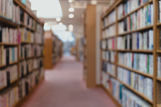 istock Quiet Library Aisle in Defocus、Blurred Bookshelves – Library Background 2224799125