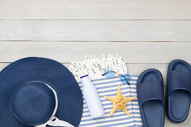 istock Blue beach accessories on wooden background, top view. Copy space for text 2224802038