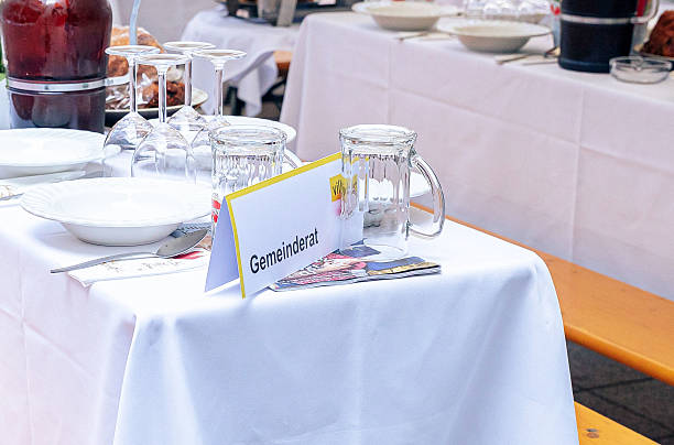 Villach, Austria - July 28, 2024: Table prepared for Villacher Kirchtag event with glassware, plates, and a name card, highlighting local traditions and festive ambiance