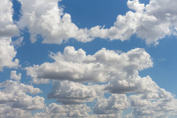 istock Bright clouds drift across a clear blue sky during midday 2224804069