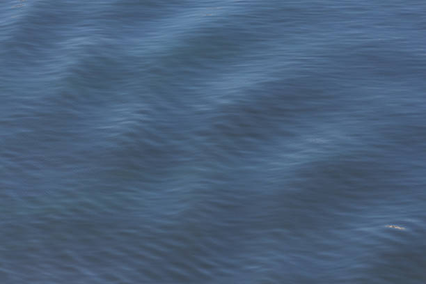 istock Calm blue water surface reveals gentle ripples 2224804120