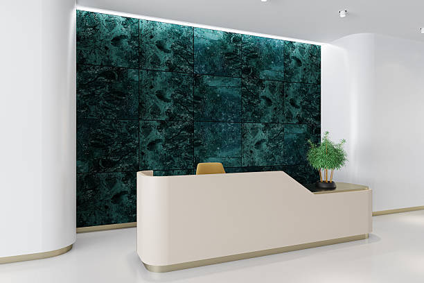 istock Minimalist Reception Interior with Beige Gloss Desk and Green Marble Feature Wall 2224805844