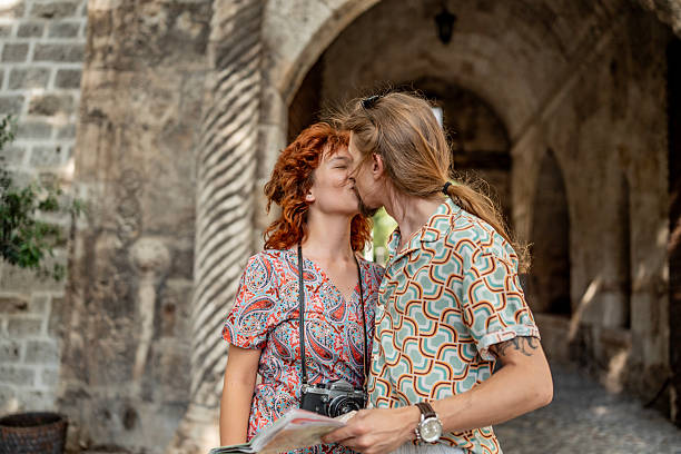 Couple stand under archway in old town together