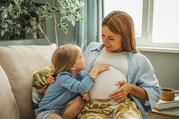 istock Pregnant mother and her daughter hugging 2224807812
