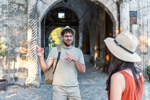 istock Tourist guide explaining history to traveler in ancient archway 2224809739