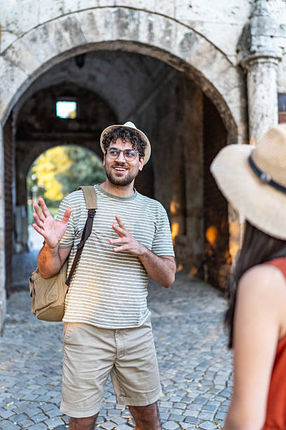 istock Tourist explaining something to a friend underneath an arch 2224809767