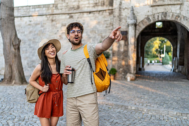istock Tourists exploring ancient city gate, enjoying summer vacation together 2224809819