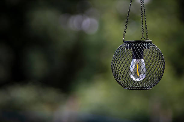 istock Hanging solar garden lamp illuminating backyard with filament led bulb 2224814953