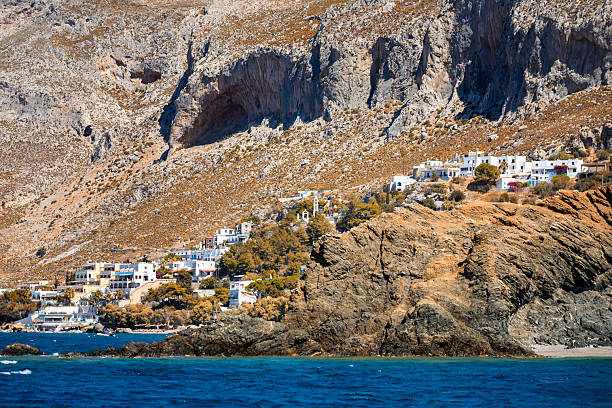 Coastal Village Scene with White Buildings and Rocky Outcrop on the Greek island of Telendos