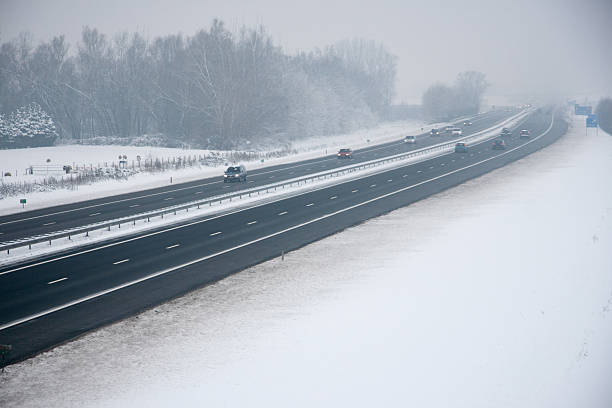 istock Traffic on the highway during snowfall and fog. 2224819867