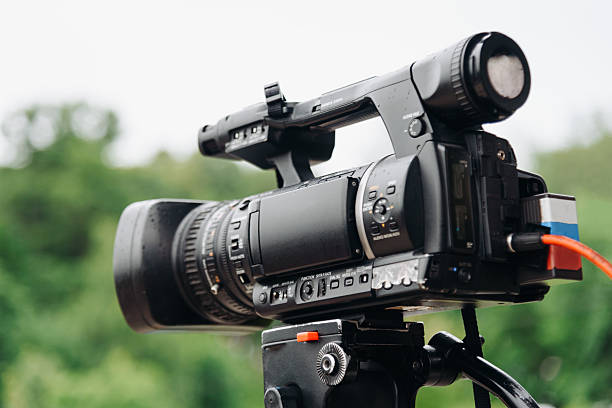 istock large black video camera on tripod outdoors 2224820310