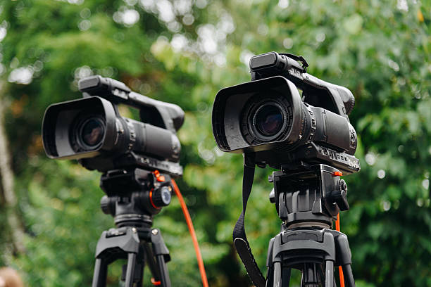 istock large black video camera on tripod outdoors 2224820335