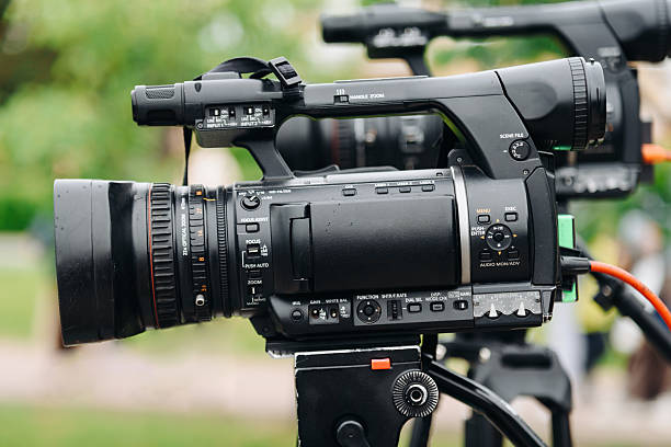 istock large black video camera on tripod outdoors 2224820336