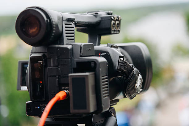 istock large black video camera on tripod outdoors 2224820337
