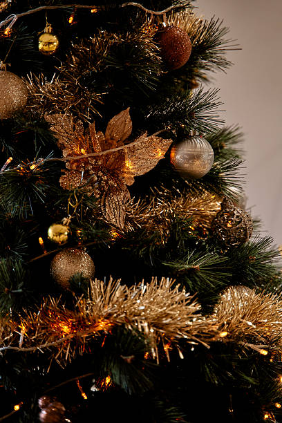Elegant christmas tree decor with gold ornaments and lights stock photo