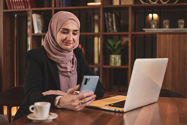istock A happy Muslim business woman using a phone while working at the office. 2224828549