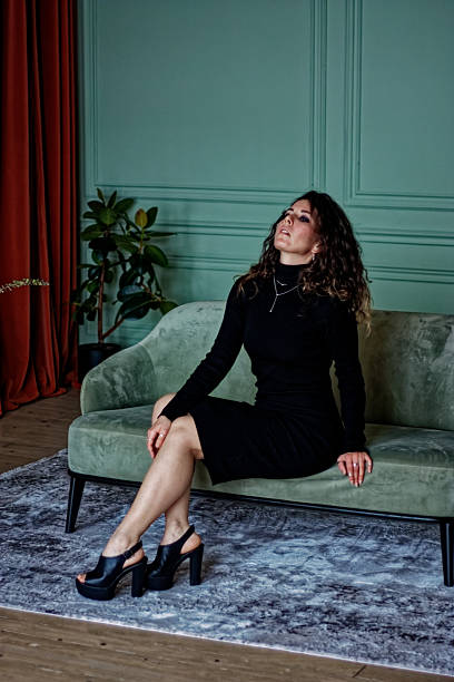 Young woman sitting on the green sofa