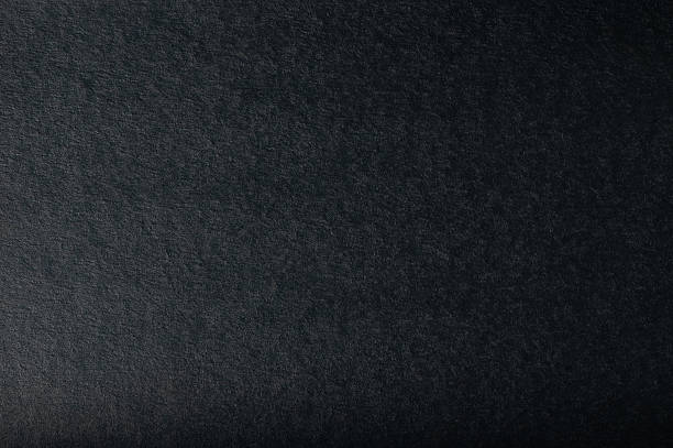 Black paper textured surface ideal for artistic and design endeavors