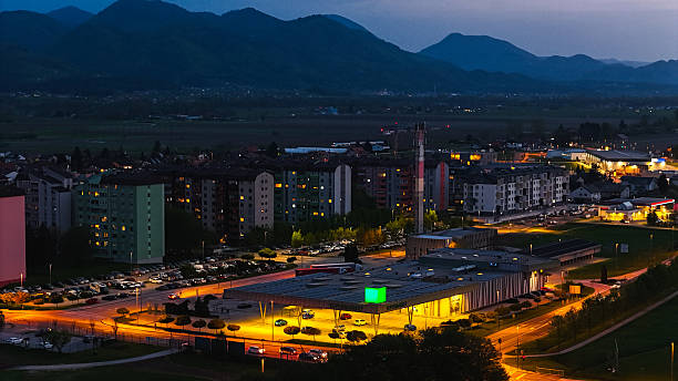 istock Cityscape at Dusk with Illuminated Buildings and Mountains 2224831926
