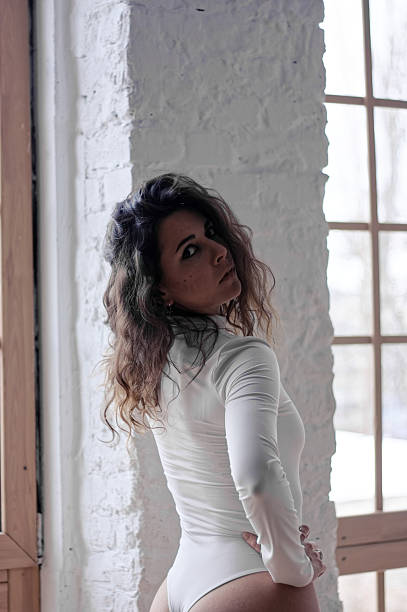 istock A young woman in white bodysuit in studio 2224832274