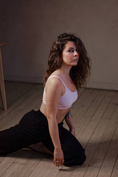 istock A young woman in white bra and black pants 2224832942