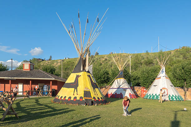 Calgary, Alberta, Canada. Jul 10, 2025. Colourful teepees stand proudly at the Elbow River Camp, a vibrant cultural display under a clear blue sky, celebrating Indigenous heritage.