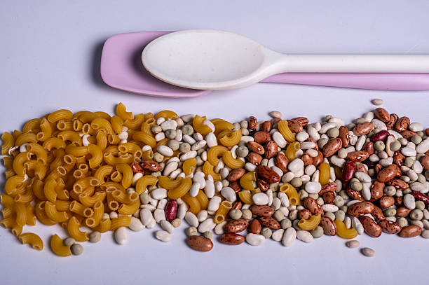 Plastic spoons and pasta and beans laid out for cooking.