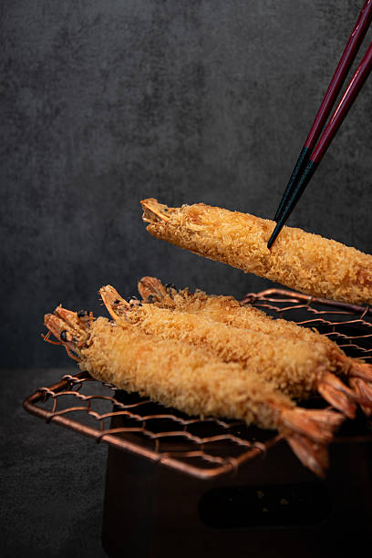 Golden Tempura Shrimp on a Wire Rack with Chopsticks