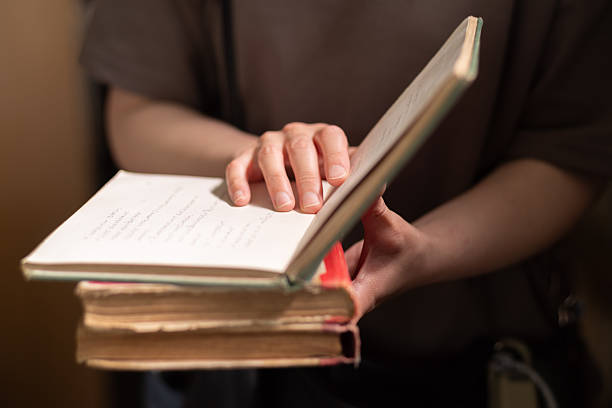 istock Person reading a book indoors 2224854273
