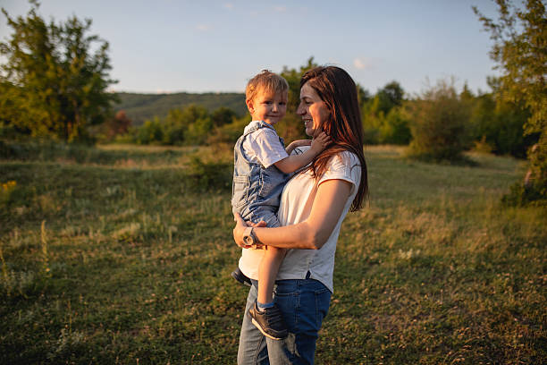 istock Golden hour embrace between mother and son in nature 2224855828