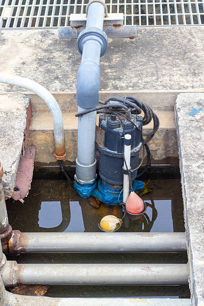 istock Industrial sewage pump in a pit with exposed pipes, 2224855998