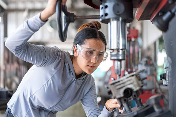 istock Skilled Asian Woman Mechanic Machining an Engine Part on a Drill Press in a Workshop 2224856722