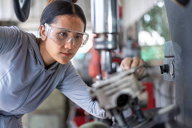 istock Skilled Asian Woman Mechanic Machining an Engine Part on a Drill Press in a Workshop 2224856883