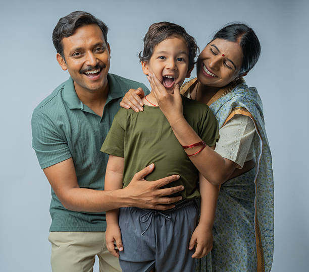 istock Loving parents with cute son standing on white background 2224856995