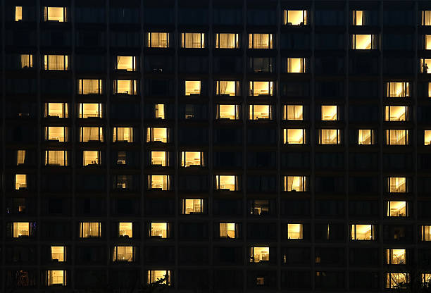 istock A tall building with many windows is beautifully lit up at night 2224857139