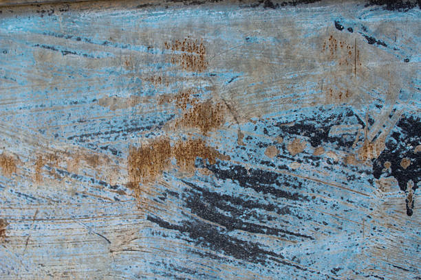 abstract concrete textured surface with a distressed appearance and copy space. weathered background with old paint brush strokes evident