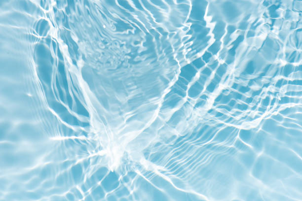 istock Blue water with ripples on the surface. Defocus blurred transparent blue colored clear calm water surface texture with splashes and bubbles. Water waves with shining pattern texture background. 2224858506