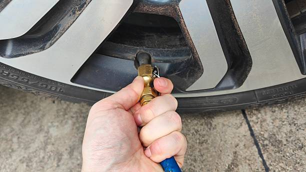 istock One hand holds a brass hose clamp. 2224860730