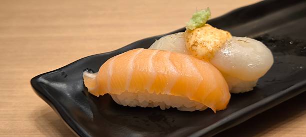 istock Sushi on a black plate on a wooden table 2224861017