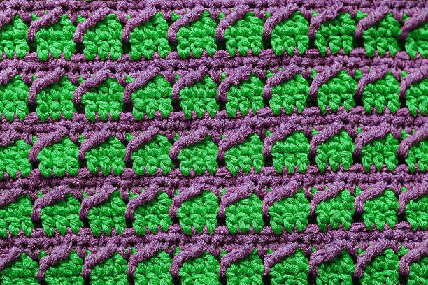 Violet light green seamless knitted texture. Volumetric crochet striped pattern. Knitted background.