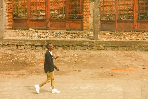 African boy sitting on stairs looking at the camera.
