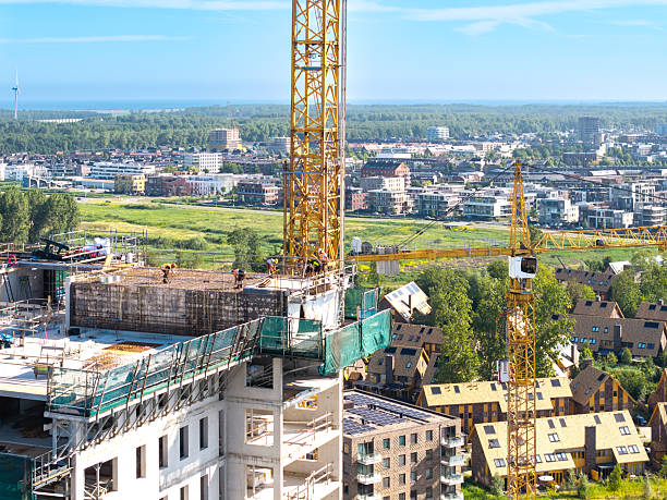 istock High-rise apartment under construction with cranes and scaffolding 2224870799