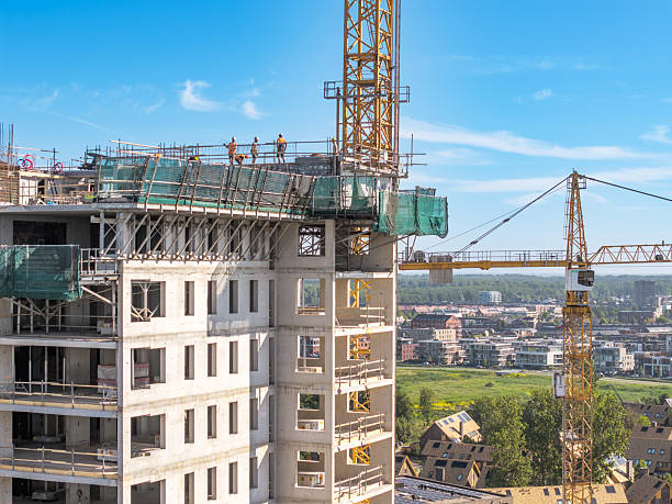 istock High-rise apartment under construction with cranes and scaffolding 2224870801