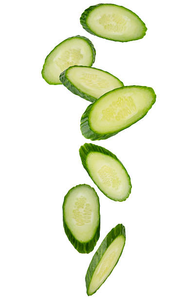 istock Cucumber slices oval serving form for table setting fall in space. Isolated on white 2224872731