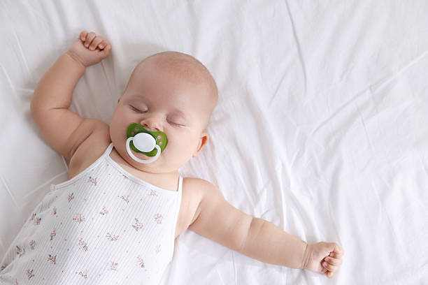 istock Cute little baby sleeping on bed at home, top view 2224877658